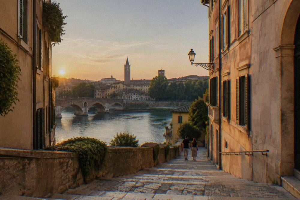 A polished stone-paved lane in Verona with shallow steps climbing between old walls