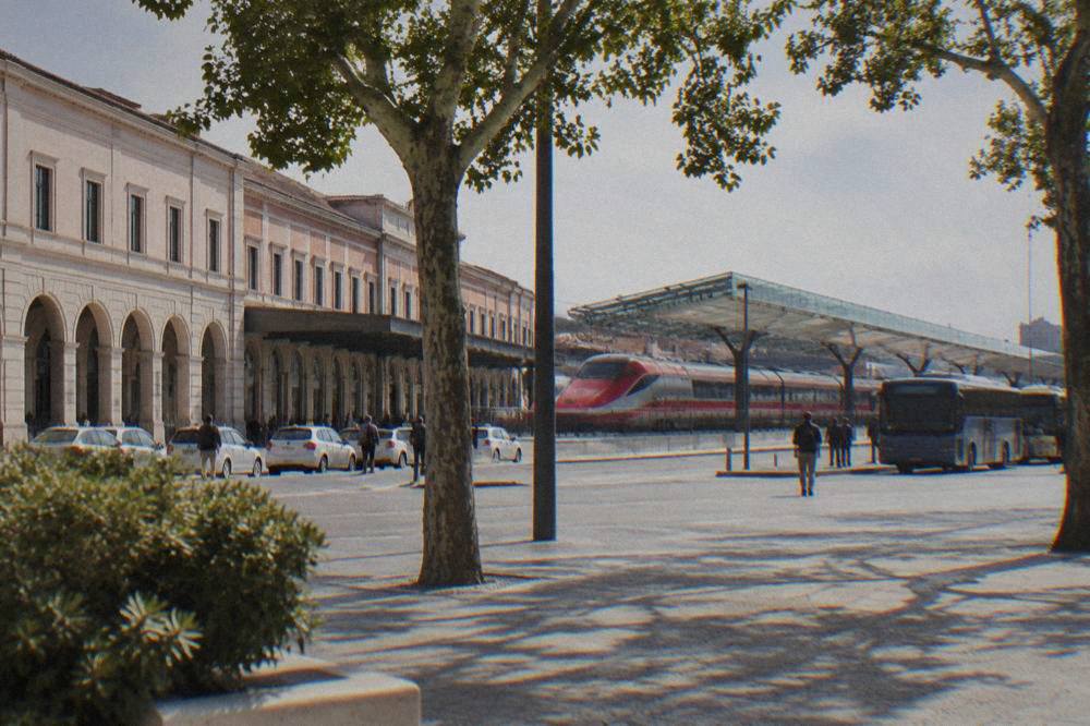 A high-speed train parked under the modern glass canopy of Verona Porta Nuova station