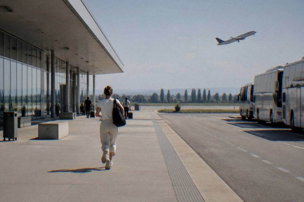 A plane climbing above the flat Veneto countryside after takeoff from a regional airport