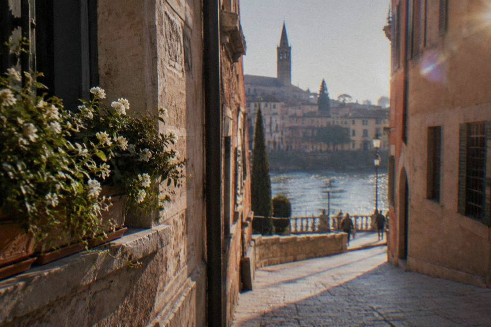 A camera-monitored restricted traffic zone sign on a historic Verona street