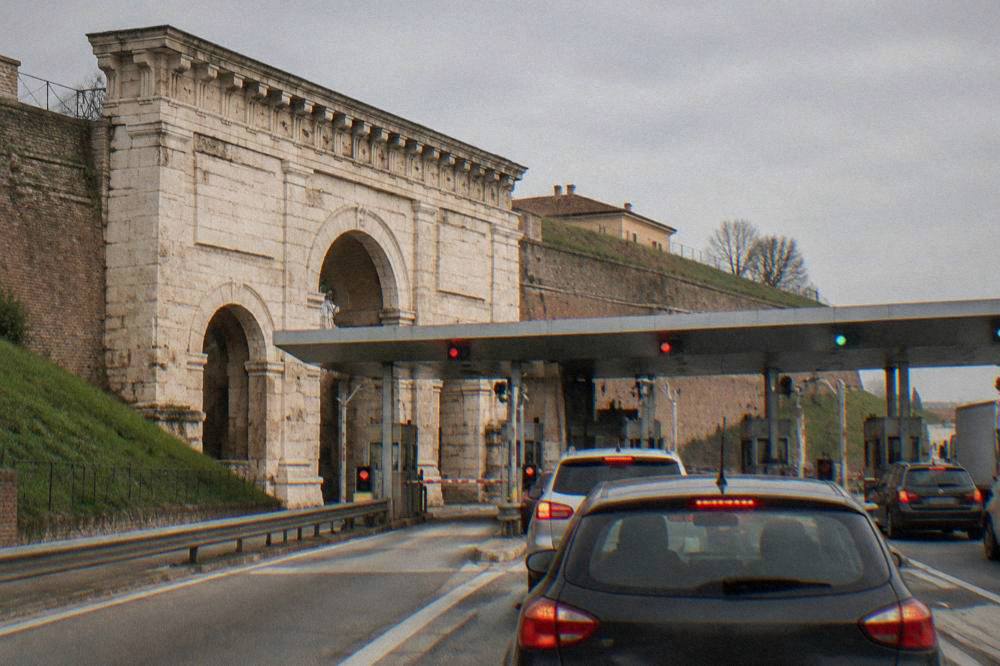 An Italian motorway toll gate with cars waiting at the barriers