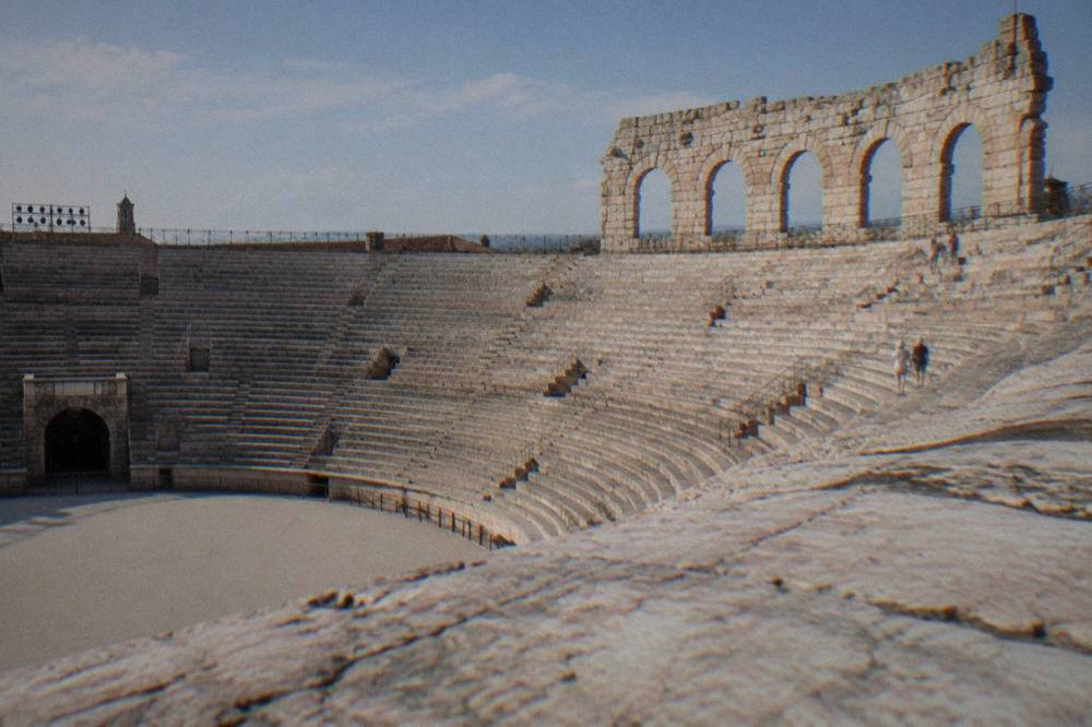 The empty stone steps inside the Verona Arena amphitheatre under an afternoon sky