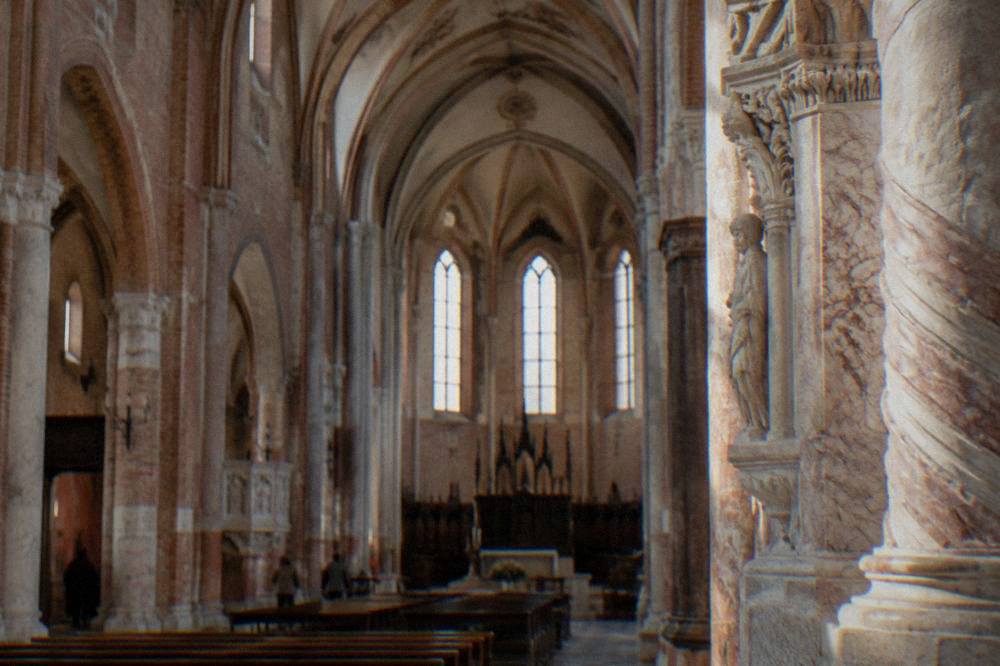 A church interior with a low vaulted ceiling giving way to taller Gothic arches above