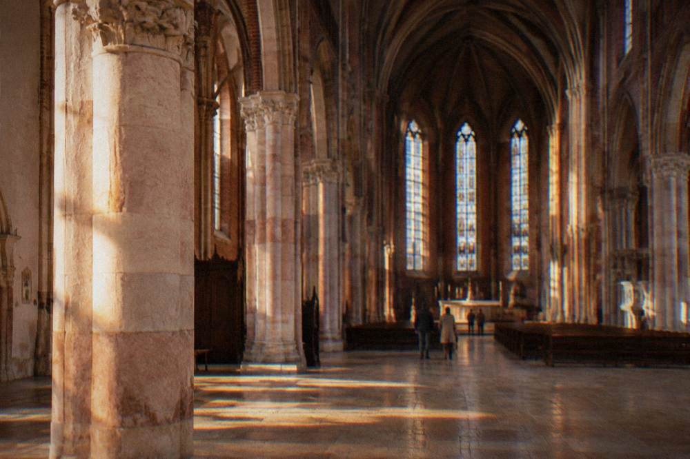Interior arch of a Gothic church with a stone floor