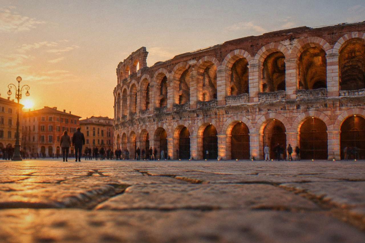 The Roman Arena of Verona lit up in the evening above Piazza Bra