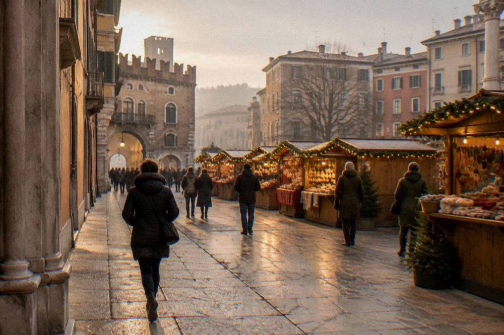 Wooden Christmas market stalls with warm lights set out in a Verona square
