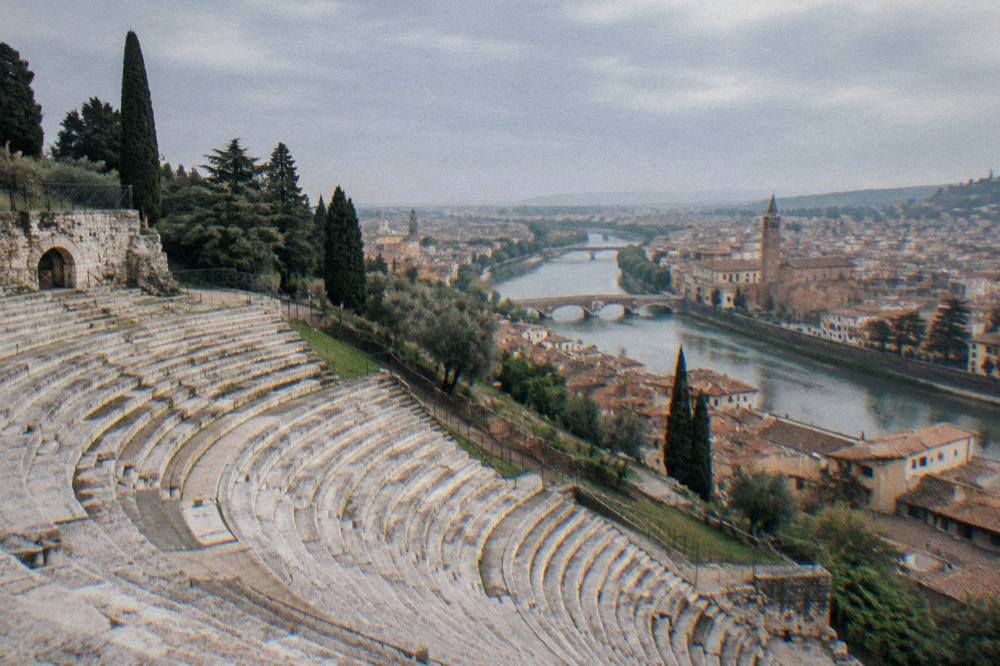 The Adige river curving past Verona's old bridges and rooftops seen from above