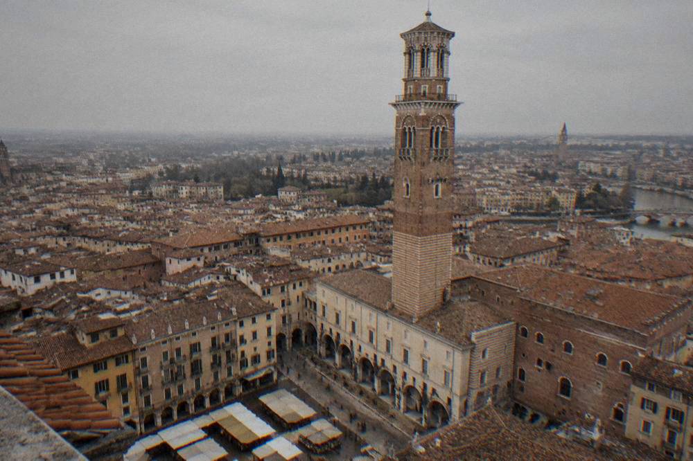 The brick Torre dei Lamberti tower rising above the rooftops near Piazza delle Erbe