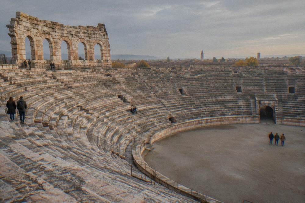The Verona Arena interior in autumn with empty stone tiers under a grey sky