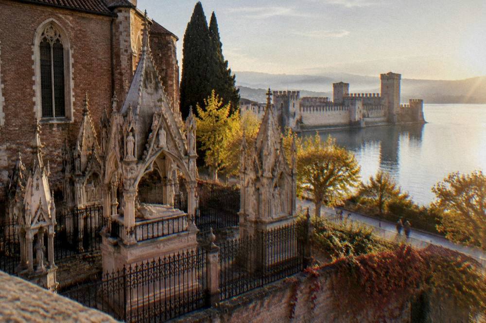 Scaliger castle at Sirmione on Lake Garda under an autumn sky with calm water