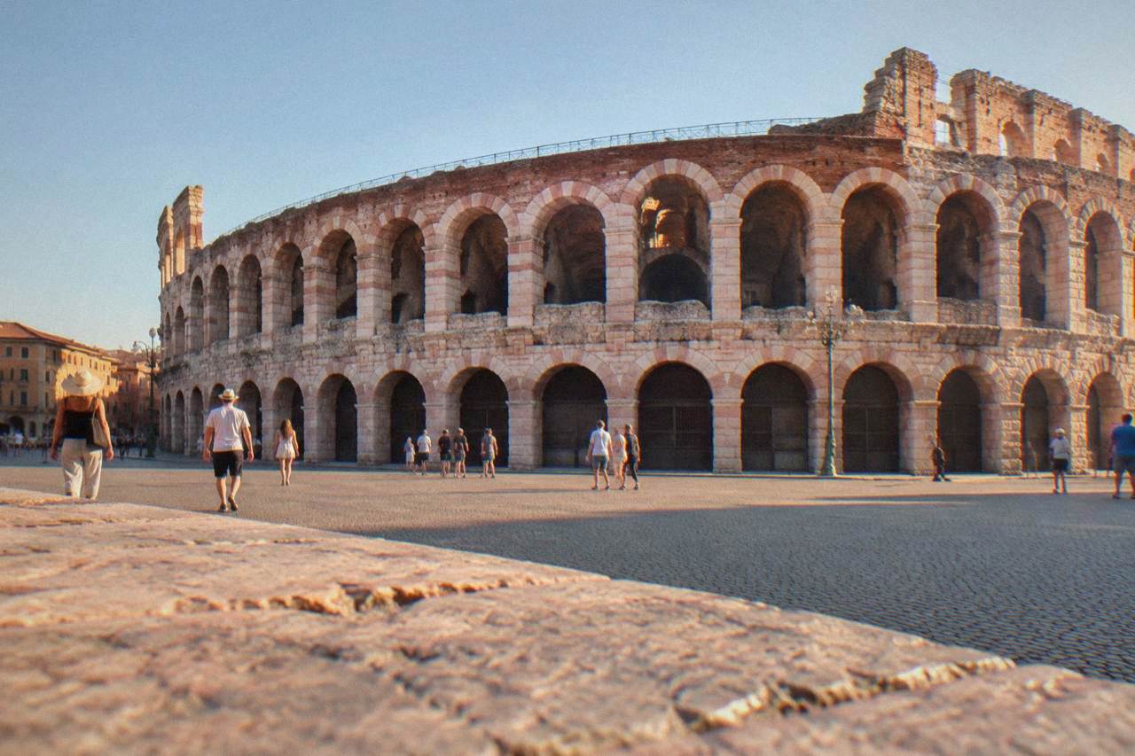 The Roman Arena of Verona lit by evening light above Piazza Bra in summer
