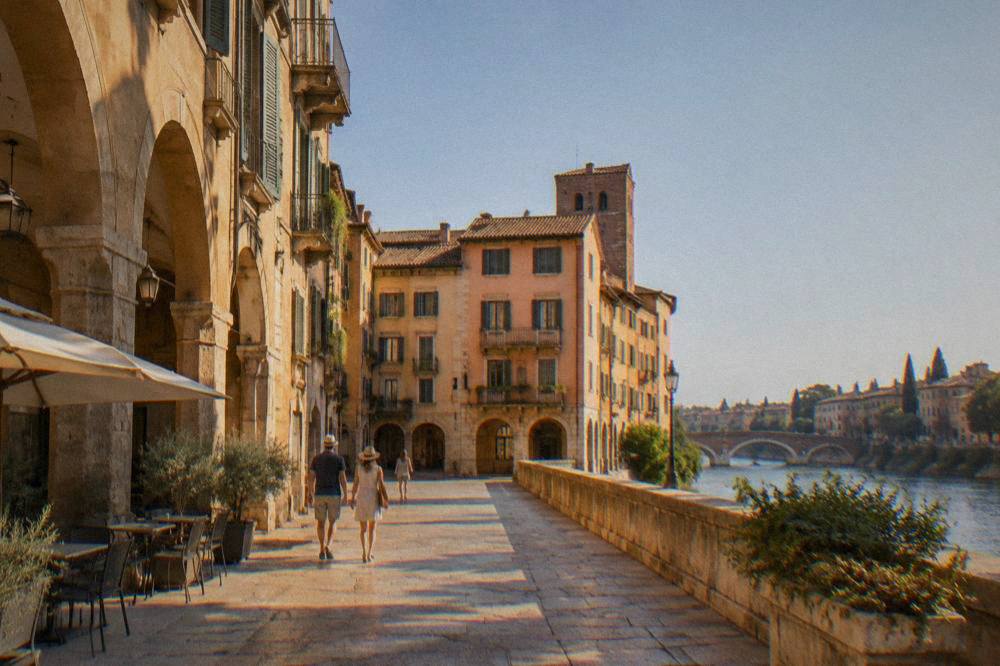 A quiet Verona street with warm stone buildings and shuttered windows in late afternoon light