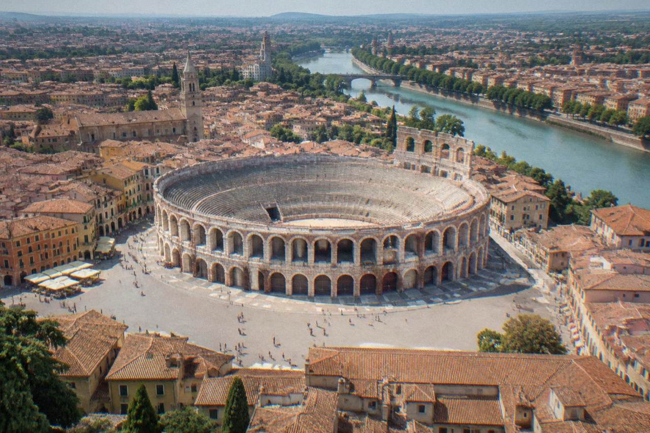 Aerial view of Verona's rooftops inside the Adige river bend with the Arena amphitheatre at the centre