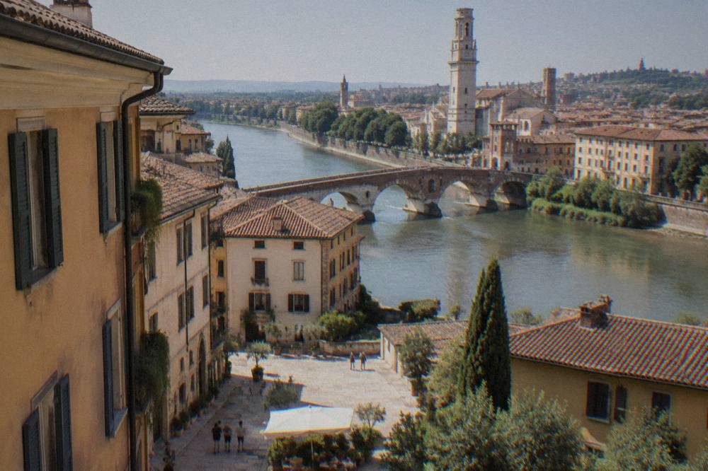 The Adige river curving past Verona's old bridges with the city skyline behind