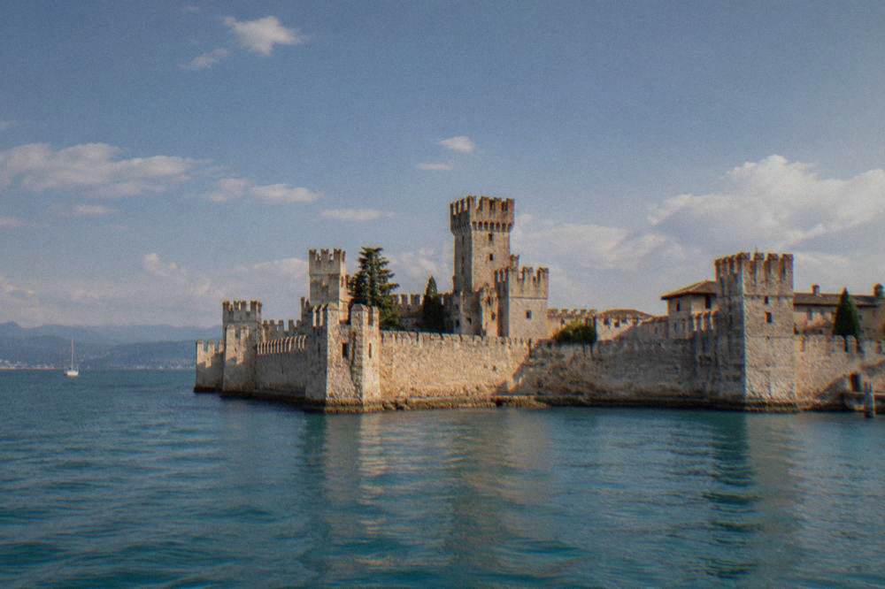 Sirmione's Scaliger castle at the tip of the Lake Garda peninsula seen from the water