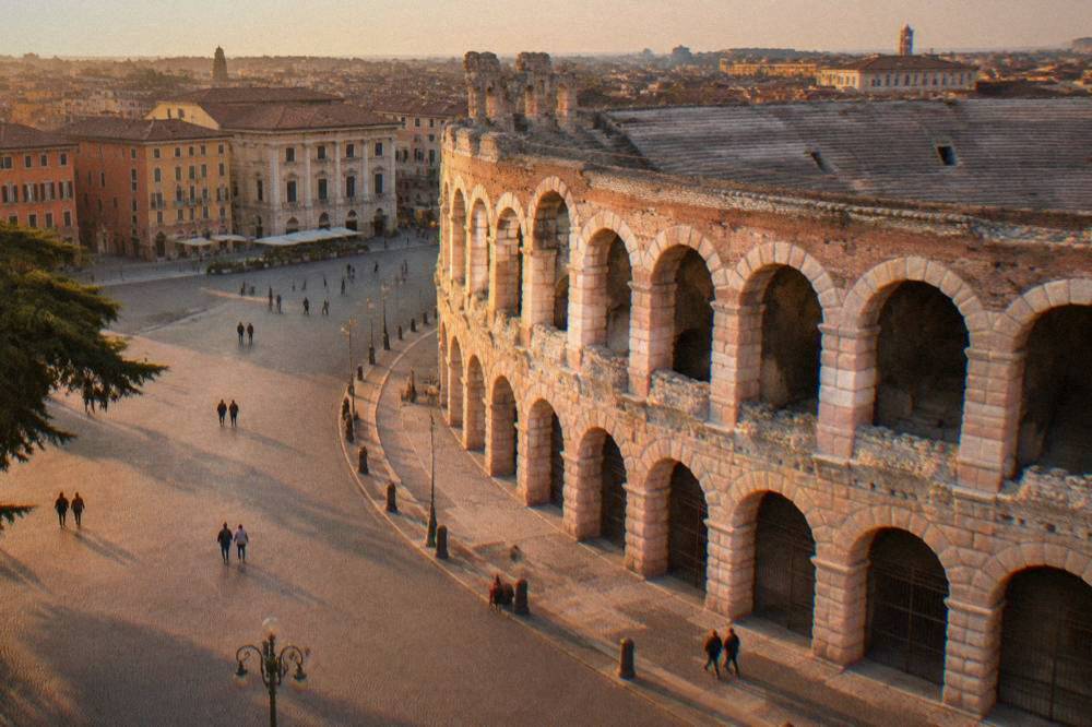 The pink marble facade of the Verona Arena filling one side of Piazza Bra