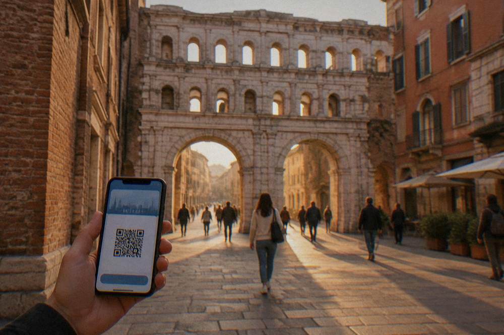 A smartphone showing a digital city pass held up in a European square