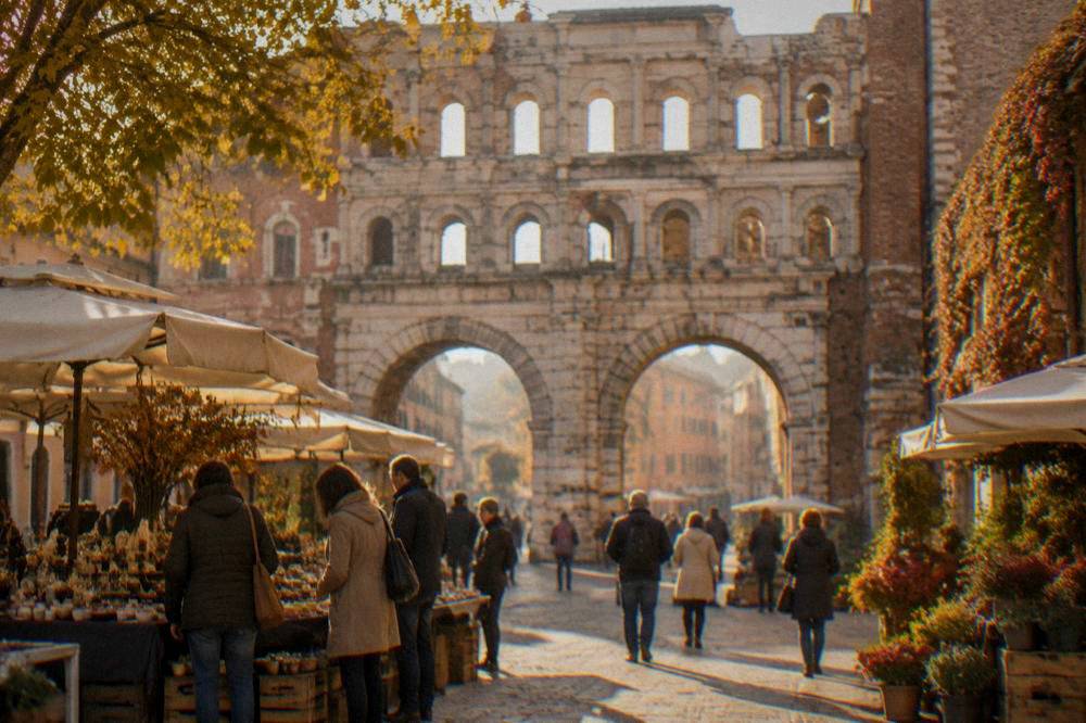 People browsing an outdoor market stall in an Italian square in autumn light