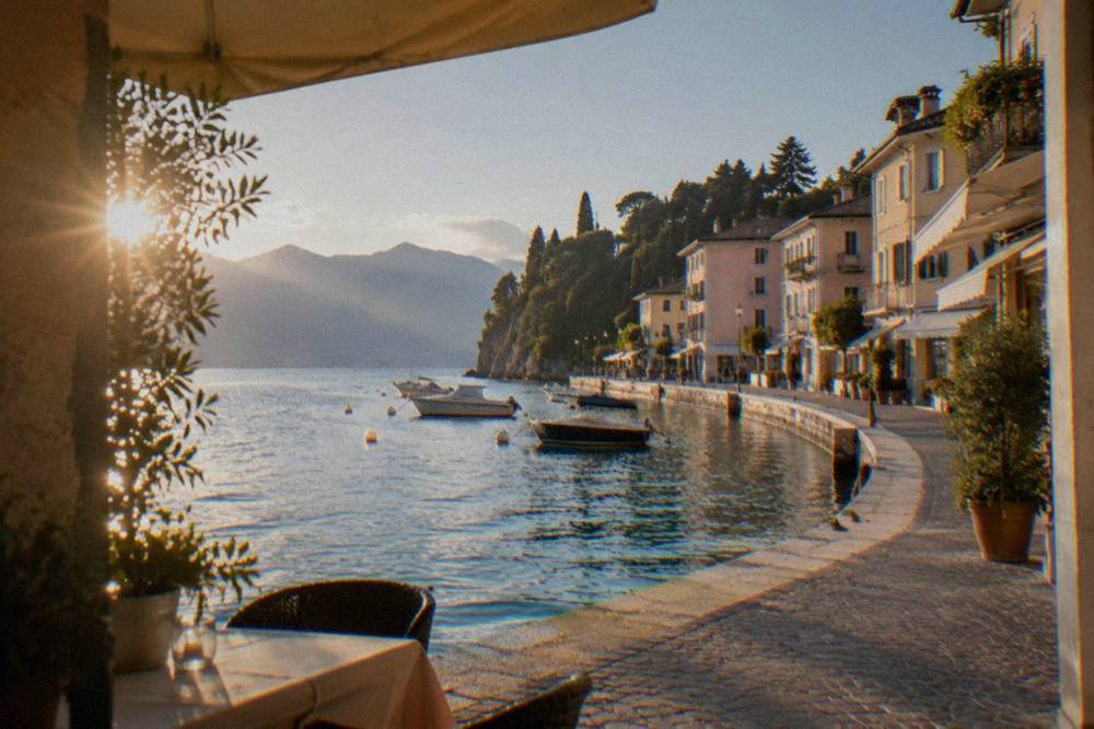 A lakeside town on Lake Garda with a stone quay and shopfronts in the evening