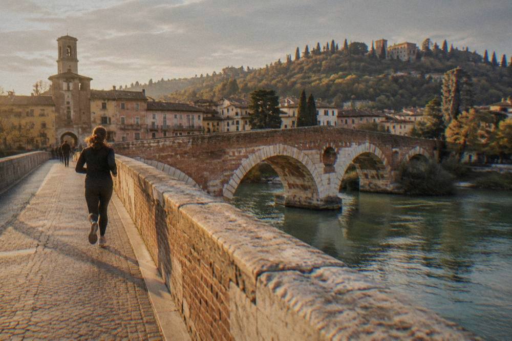 The Adige river curving past Verona's old bridges on an overcast afternoon