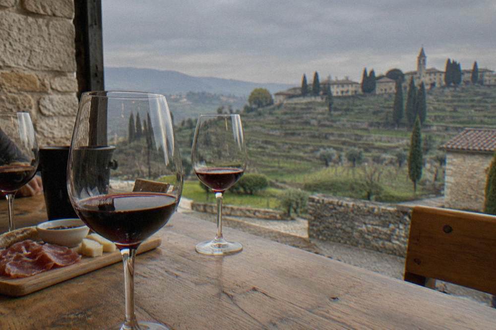 Wine glasses on a wooden tasting table in a Valpolicella cellar