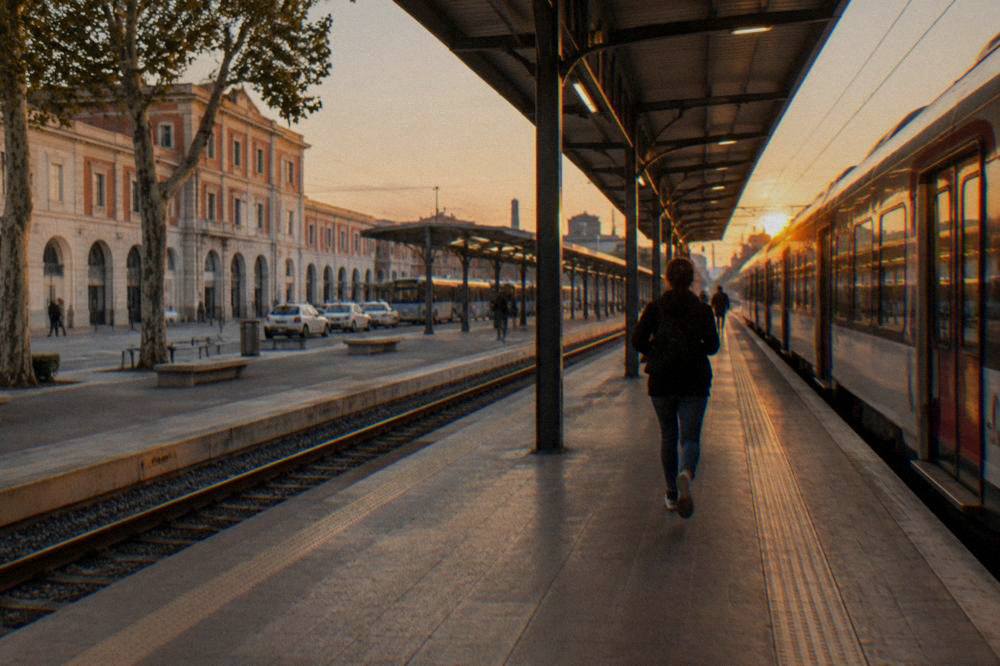 Verona Porta Nuova station platform at dusk with a waiting train