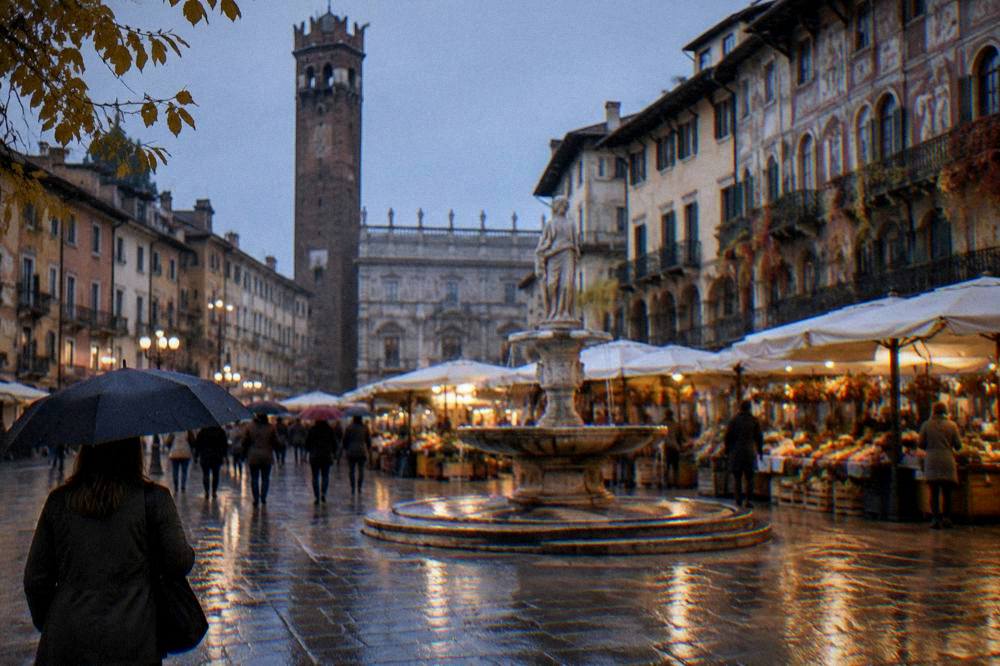 Wet cobblestones and umbrellas in Piazza delle Erbe during autumn rain