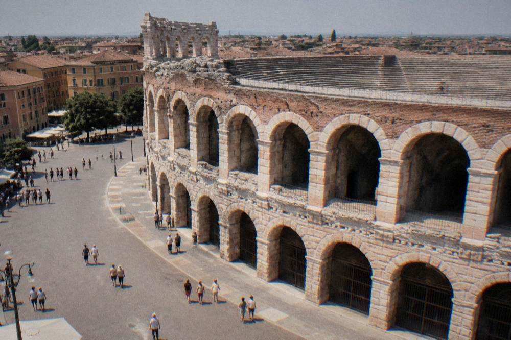 Stone arches of the amphitheatre glowing at dusk