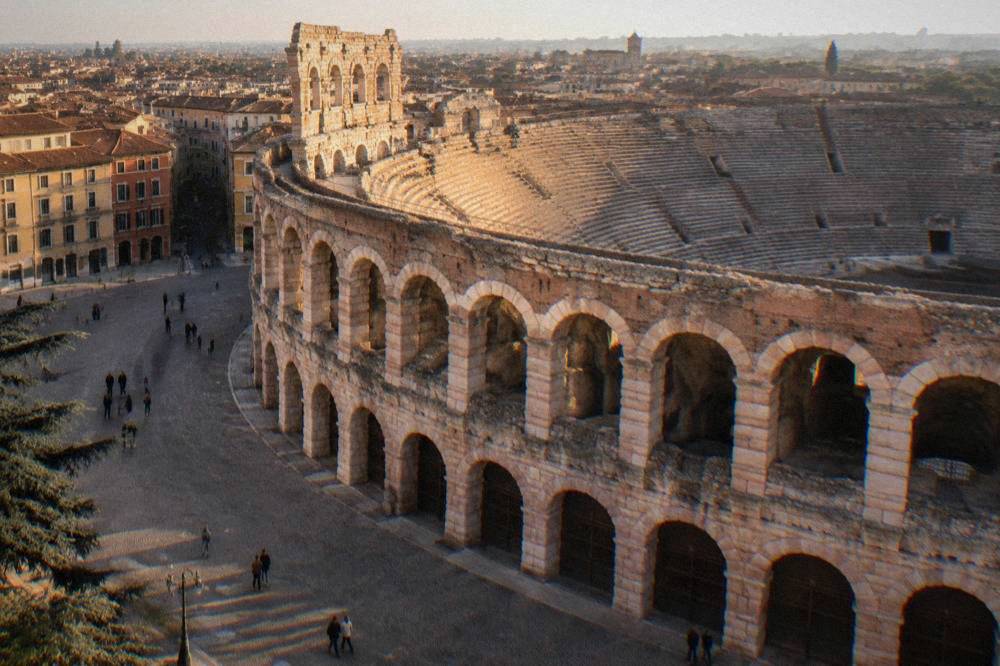 The stone steps and arches inside the Arena of Verona in morning light