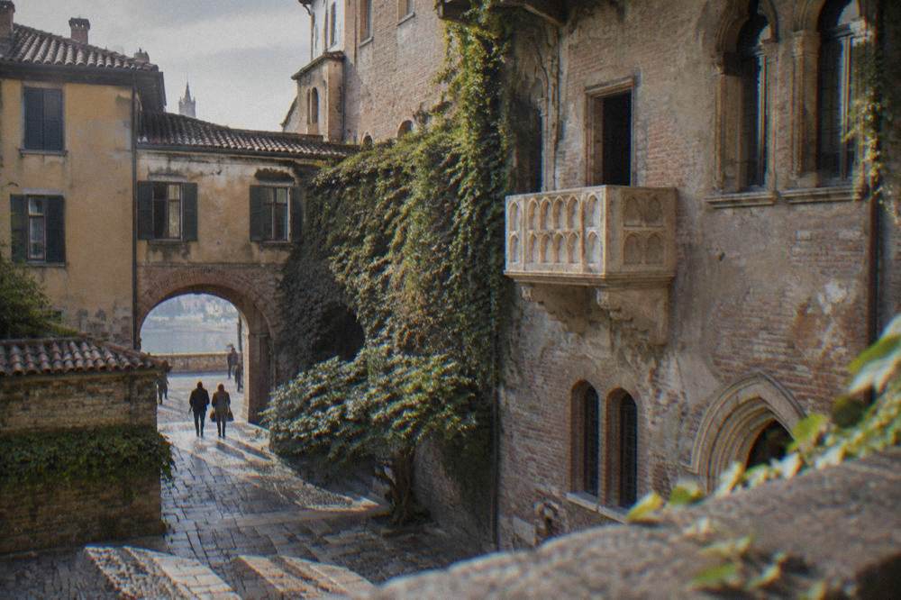 Juliet's stone balcony above the small courtyard in Verona