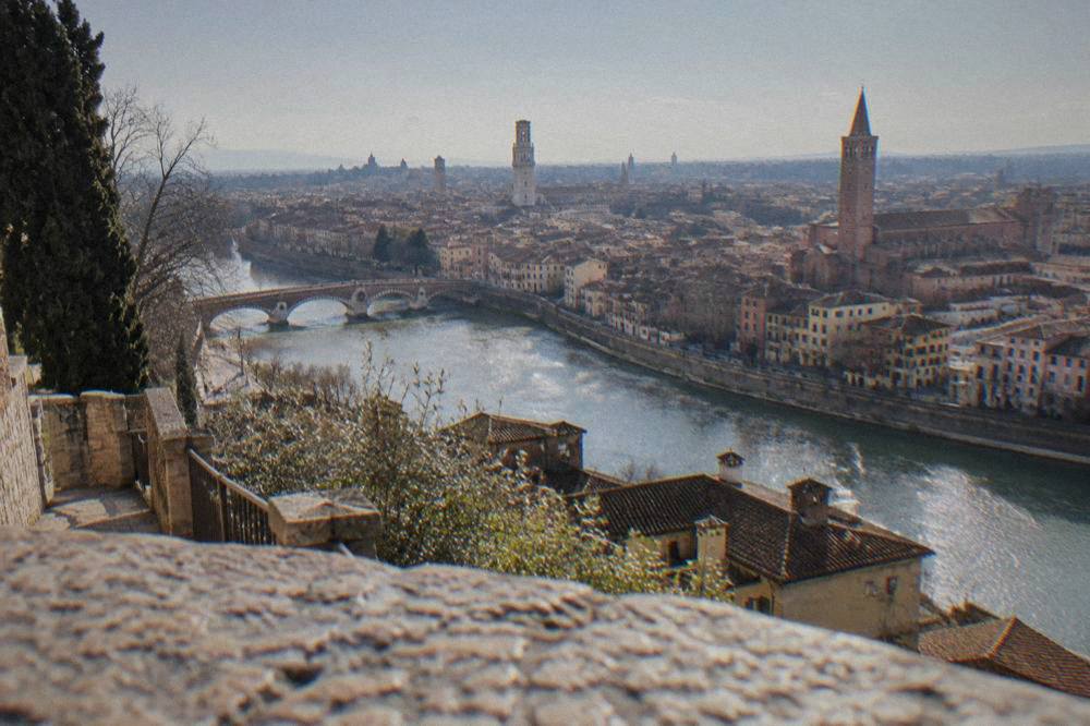 Verona rooftops and the Adige river seen from a hillside terrace