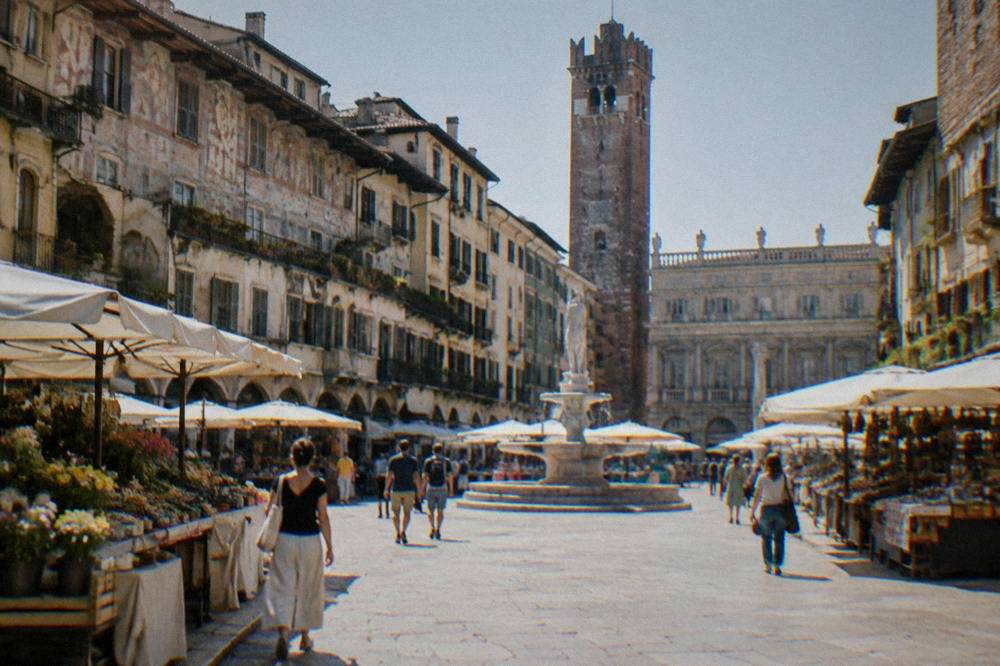 Market stalls and painted facades around Piazza delle Erbe in Verona