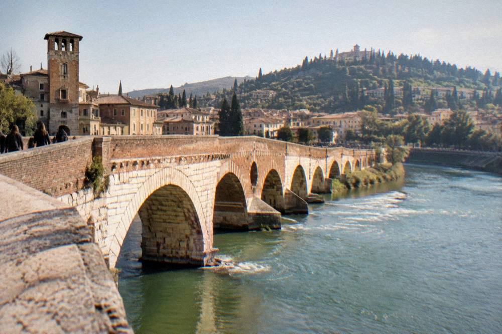 The Adige river curving past Verona with Ponte Pietra in the foreground