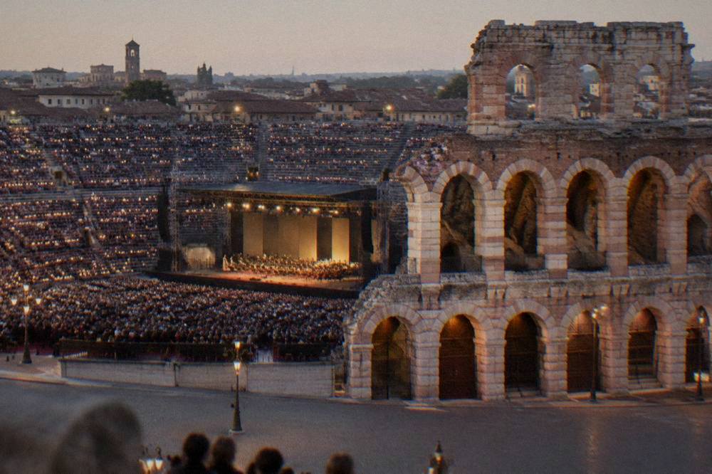 Candle-lit stone steps of the Arena filled for an evening opera performance