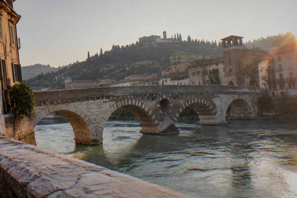 Ponte Pietra, the Roman bridge over the Adige, with the Verona hills behind