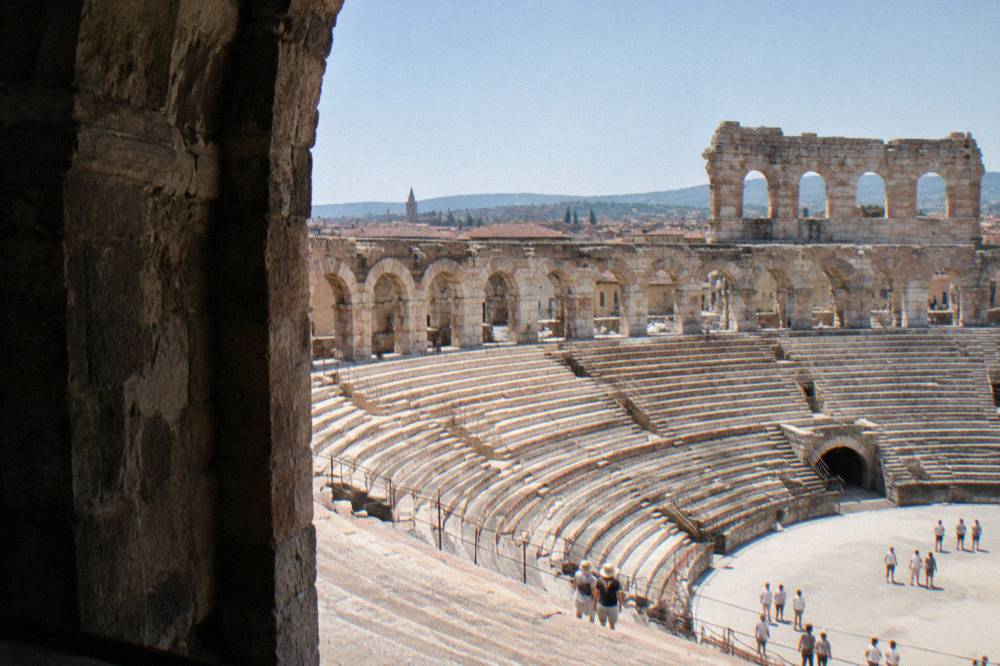 The stone arches and seating of the Verona Arena seen from inside the amphitheatre