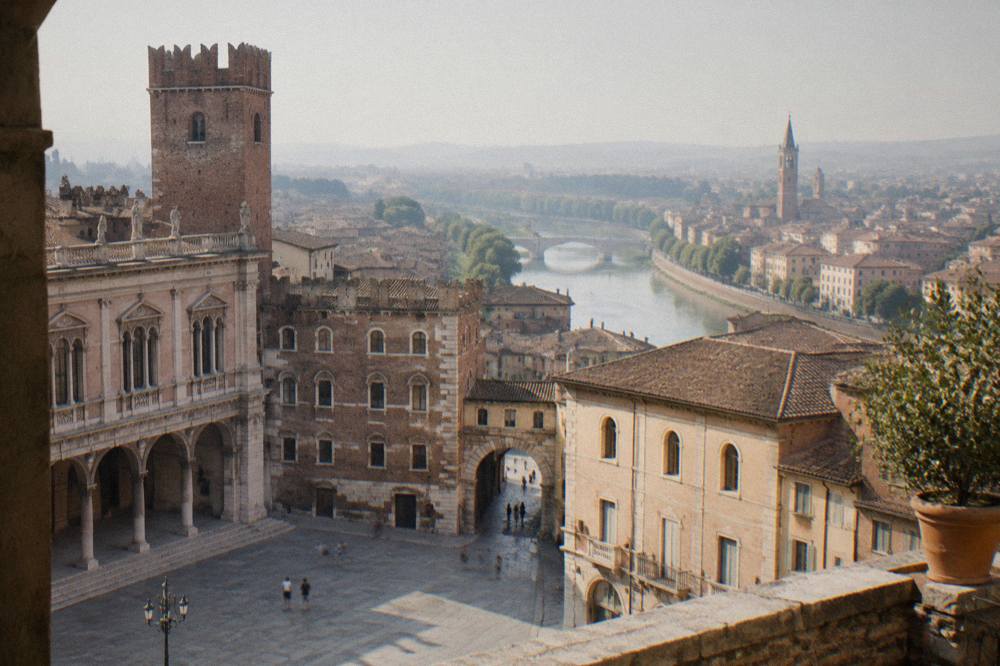 A panoramic view over Verona's rooftops and river from a hillside terrace